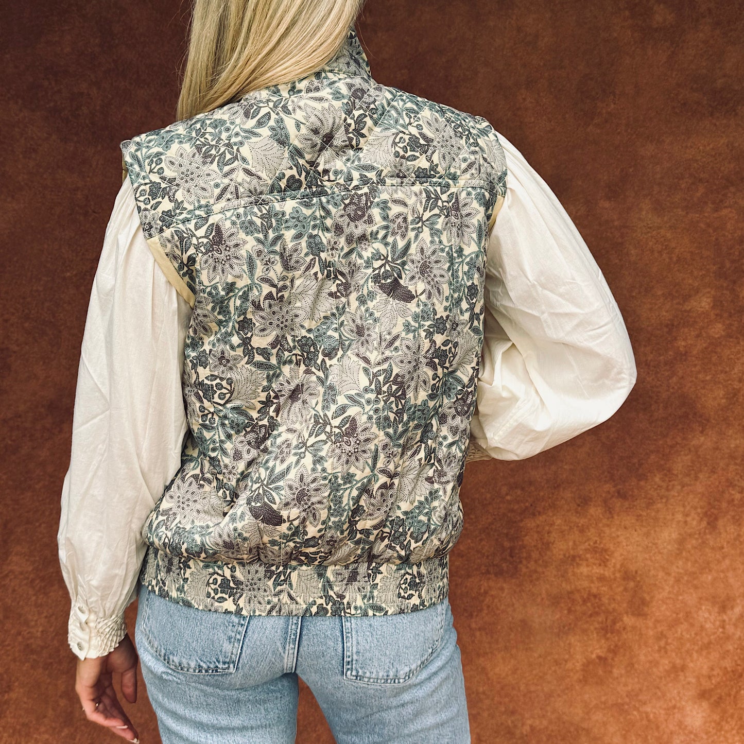 Quilted Frida sleeveless jacket in woodland floral print cotton lawn.